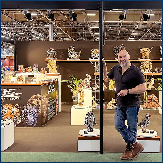 Matt Buckley at an Edge Sculpture exhibition display stand at a trade show