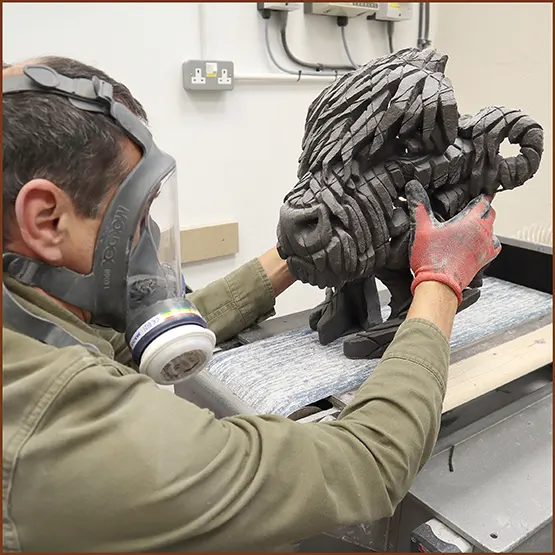 Picture showing the section of a Highland Cow sculpture casting having the base sanded