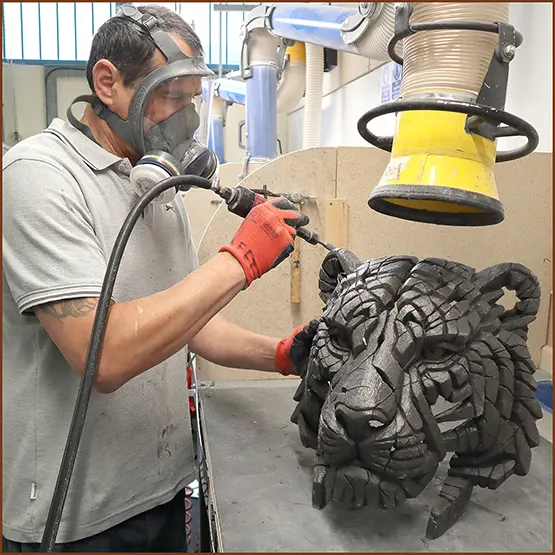 Picture showing a Siberian Tiger sculpture casting being fettled and finished with an air drill.