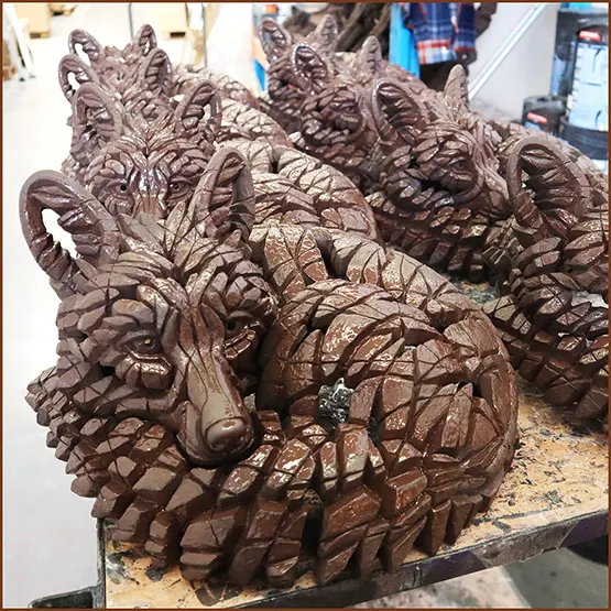 Picture of several Fox sculpture castings together on a trolley once they have been undercoated