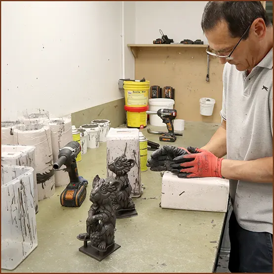 Picture of a Field Mouse sculpture casting being removed from a silicone production mould.