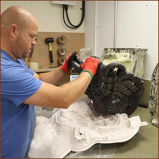 Picture of a Siberian Tiger sculpture casting being removed from a silicone production mould.