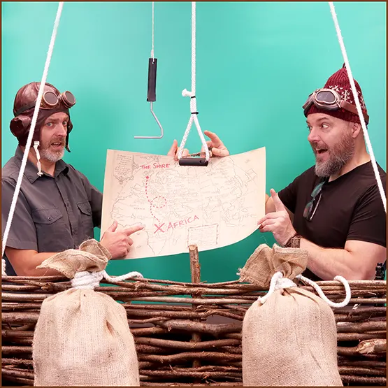 Matt Buckley and Dan Buckley filming themselves for a YouTube presentation in front of a green screen