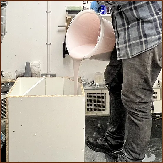 Picture of silicone rubber being poured into a block mould case
