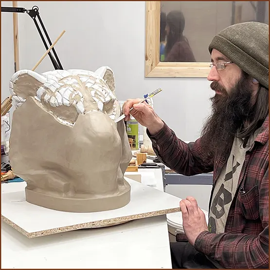Nick our mould maker claying up a Tiger production master