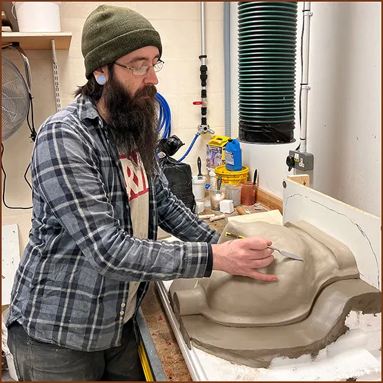  Nick our mould maker using clay to create a shape for a production mould