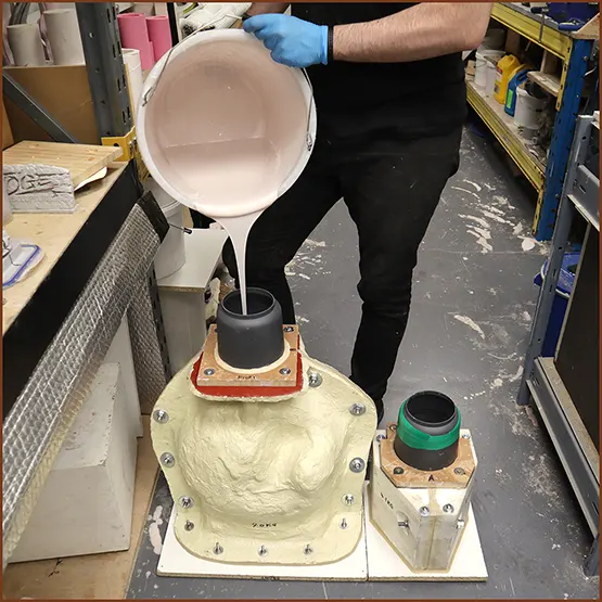 Picture of silicone rubber being poured into the master production mould case