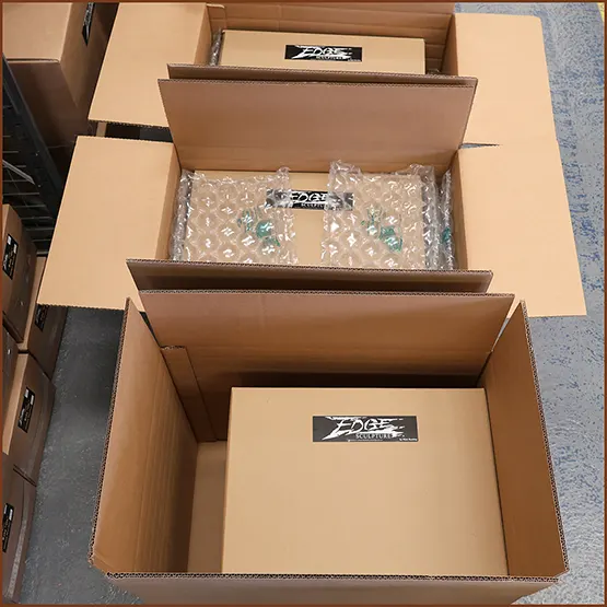 Picture of packaged pieces being placed in outer boxes
